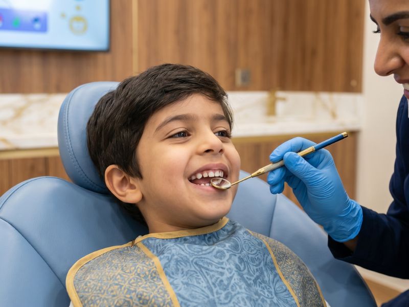 Pediatric dentistry — friendly dentist with young patient
